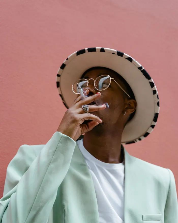 Well-dressed American consumer enjoying a premium tobacco product, the market smokeless tobacco brands serve